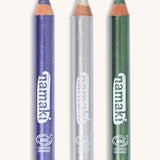 A green, silver and purple glitter make up pencil on a cream background