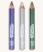 A green, silver and purple glitter make up pencil on a cream background