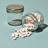 Denttabs Fluoride Toothpaste Tablet on bamboo toothbrush