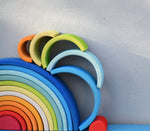 Pieces from the Grimm's Babi Gwawr Sunrise 6 Piece Rainbow stacked on top of a 12 piece Gwawr rainbow.