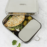 A close up of the A slice of green large lunchbox with mini container with various food items inside and the lid resting on top