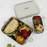 A top down image of the A slice of green large lunchbox with mini container showing different food items inside the main and mini compartment