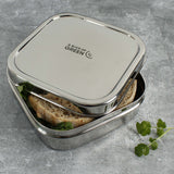 A close up of the A slice of green shimla large square container lunchbox showing the stainless steel finish detail