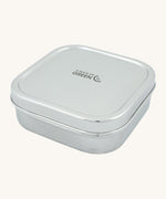 A slice of green shimla large square container lunchbox available at Babipur. A square stainless steel lunchbox with the brand logo on the lid.