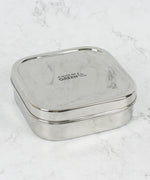 A slice of green shimla large square container lunchbox standing on a stone surface available at Babipur.