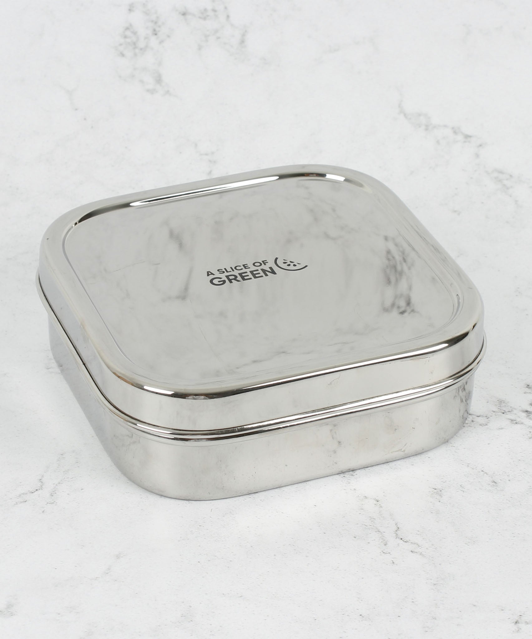 A slice of green shimla large square container lunchbox standing on a stone surface available at Babipur.