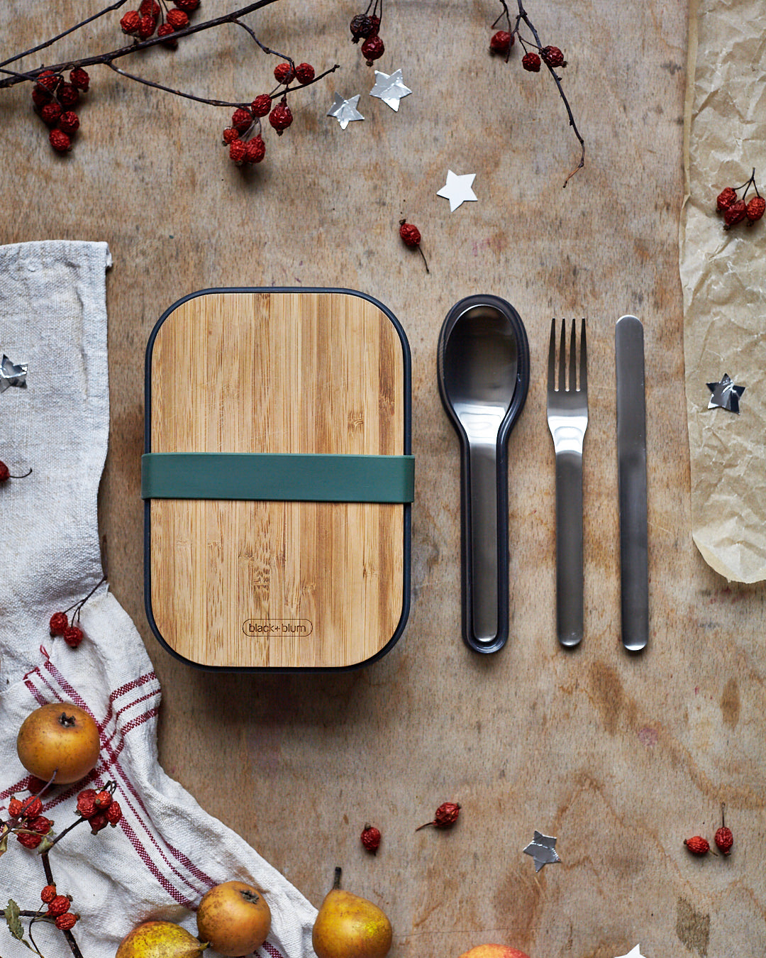 Black + Blum stainless steel cutlery set with portable hygienic carry case resting next to a olive original lunhcbox.