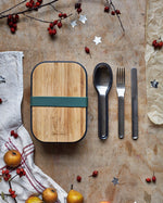 Black + Blum stainless steel cutlery set with portable hygienic carry case resting next to a olive original lunhcbox.