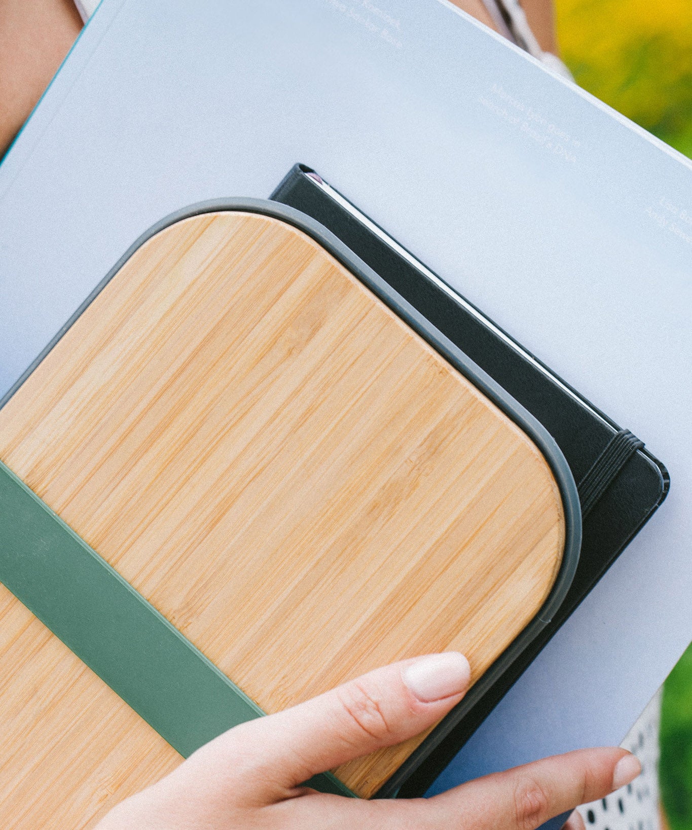 A close up of a sandwich in a Black + Blum stainless steel airtight sandwich box showing the bamboo lid detail