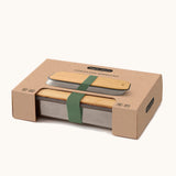 A close up of the brown cardboard packaging holding the Black + Blum stainless steel airtight stainless steel sandwich box