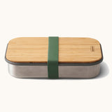 Black + Blum stainless steel airtight stainless steel sandwich box with a olive silicone holder available at Babipur. Features a bamboo lid which can be used as a prep surface or plate.
