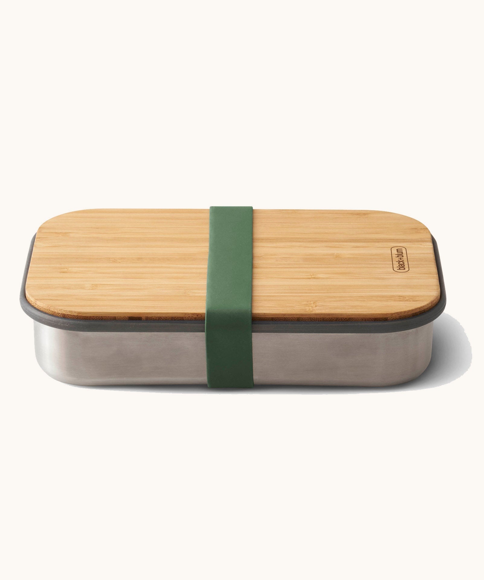 Black + Blum stainless steel airtight stainless steel sandwich box with a olive silicone holder available at Babipur. Features a bamboo lid which can be used as a prep surface or plate.