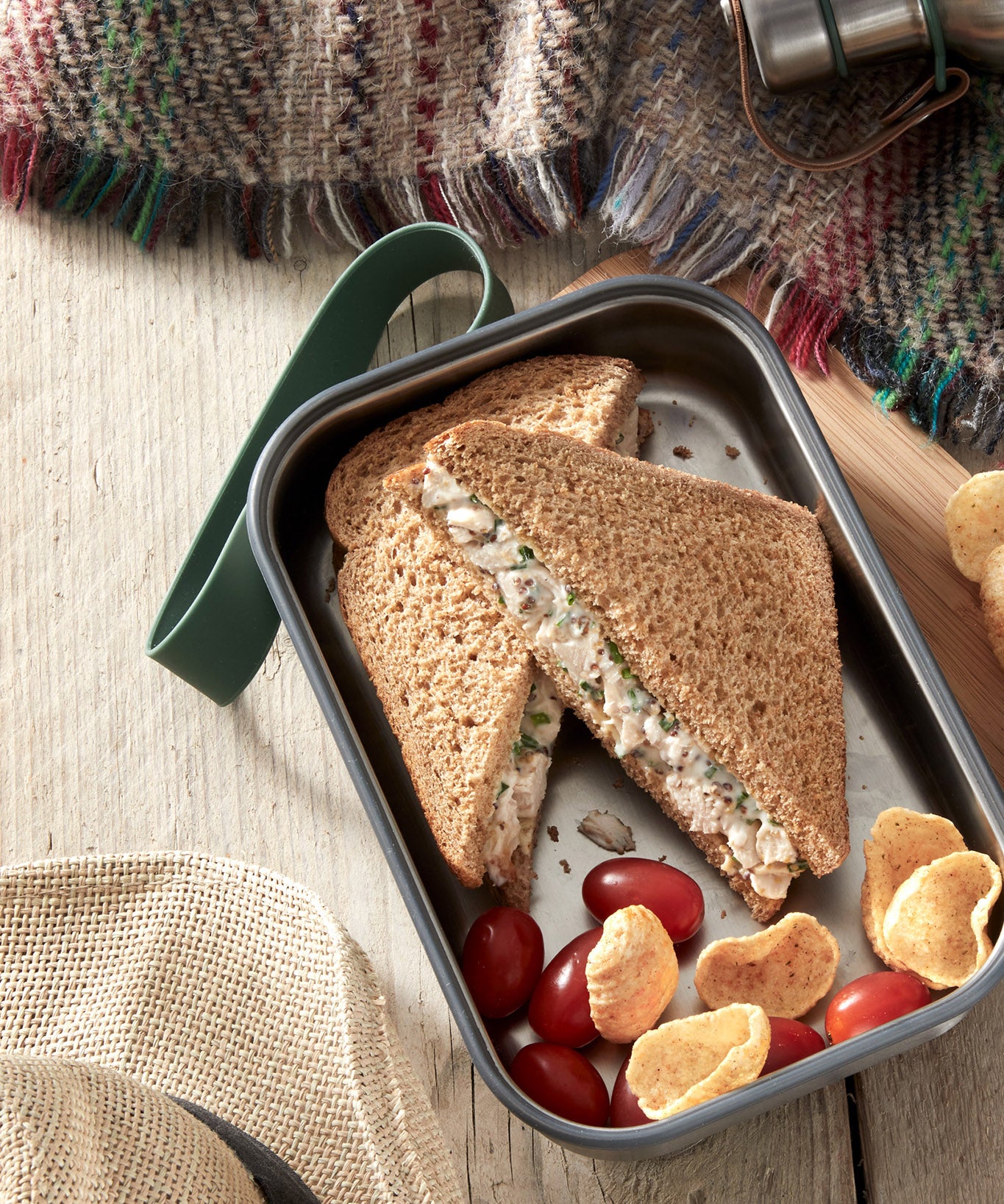 A close up of a sandwich in a Black + Blum stainless steel airtight stainless steel sandwich box