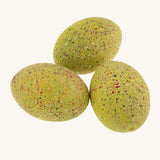 Bumbu green wooden t-rex dinosaur egg set on a plain background.