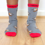 A close up of a child wearing the Eco kiddies organic cotton chirpy robbins socks showing the cute robin design and red trim detail