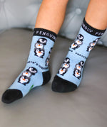 A close up of a child wearing the Eco kiddies organic cotton friendly penguins socks showing the cute playful penguin design detail