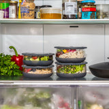 A stack of medium and large Elephant box lunch bowls in a fridge and packed with different foods. Both bowls are available at Babipur.