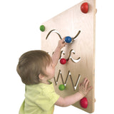 A child concentrating and moving the wooden part along the wavy maze path