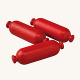 A closer look at the Erzi Wooden Mini Sausages on a cream background. The sausages show the natural wood grain through the colour, giving a realistic sausage effect.