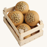 A selection of Erzi Wooden Seed Rolls, in a wooden Erzi crate, on a cream background