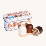 Erzi Wooden Marshmallows In A Tin. 3 Wooden marshmallows, in white chocolate, milk chocolate and dark chocolate. With a colouful metal tin behind, on a cream background