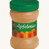 Erzi Wooden Apple Sauce jar, with a green lid and apple label. On a cream background. Perfect for playing cafe or shop