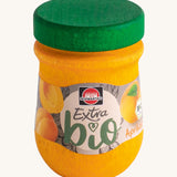 Erzi Wooden Apricot Jam. A colourful yellowand green wooden jar with an apricot jam label on the front. Perfect for playing cafe or shop, or even breakfast!