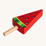 Erzi Wooden Melon Popsicle. A fun watermelon pretend play Popsicle, perfect for shop and cafe play! The popsicle is red with a natural wooden stick, watermelon seeds and green watermelon rind.