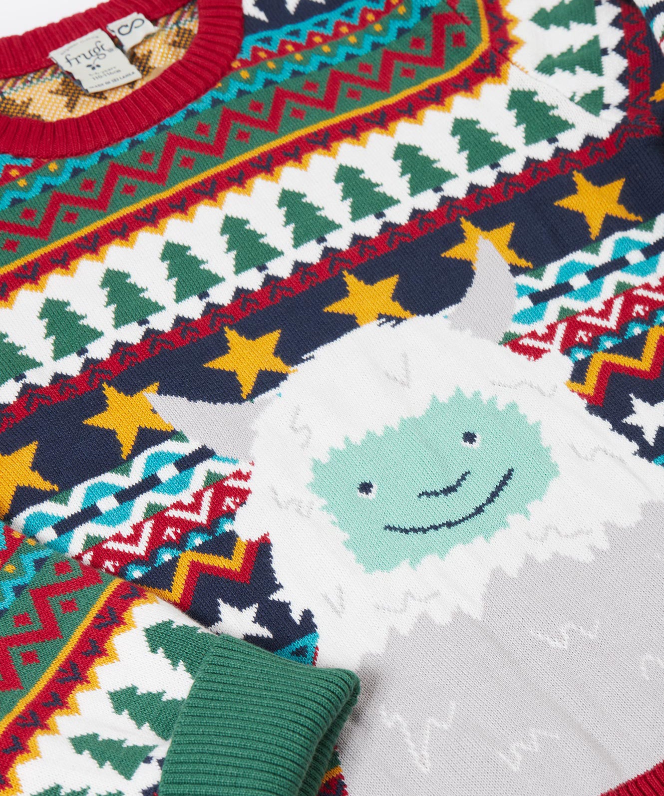 A close up of the cute playful yeti design on the Frugi forest fairisle/yeti jumper available at Babipur.
