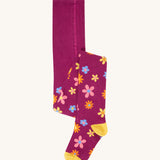 Frugi Norah tights in damson / retro floral available at Babipur. A GOTS organic cotton dark purple tights with a pastel coloured retro flower design and yellow contrasting panels