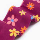 Frugi Norah tights in damson / retro floral available at Babipur. A GOTS organic cotton dark purple tights with a pastel coloured retro flower design and yellow contrasting panels