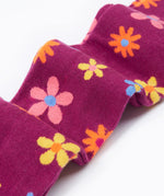 Frugi Norah tights in damson / retro floral available at Babipur. A GOTS organic cotton dark purple tights with a pastel coloured retro flower design and yellow contrasting panels