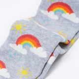 A close up of the rainbow print on the Frugi Norah tights in grey marl / rainbow available at Babipur. A GOTS organic cotton grey tights with a playful rainbow design and red contrasting heel and toe panels