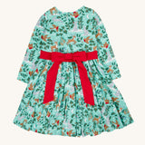 The back of the Frugi party skater dress in festive forest available at Babipur showing the red tie around the waist and tied in a festive inspired bow.