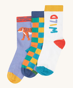 Frugi rock my socks 3 pack in stay wild multipack available at Babipur. GOTS organic cotton socks including a light purple with a tiger design, a checkered design and a white sock with stay wild slogan.