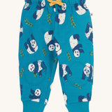 Frugi snuggle crawlers in panda pals available at Babipur. A GOTS organic cotton jooger style bottom in light blue with a playful panda print. Features soft knee patches and a yellow drawstring cord around the waist.
