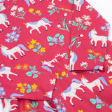 A close up of the Frugi sofia skater dress in rose / unicorn floral available at Babipur. A GOTS organic cotton dress in light pink with a cute unicorn and floral design.