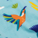 A close up of the kingfisher on the Frugi sofia skater dress in kingfisher skies available at Babipur. A GOTS organic cotton skater dress in light blue with a lovely playful kingfisher print.