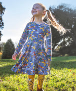 A child wearing the Frugi sofia skater dress in grape purple with a into the wild print with cheetah tights. Available at Babipur. A GOTS organic cotton lilac skater dress with a playful wildlife print.