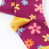Frugi Norah tights in damson / retro floral available at Babipur. A GOTS organic cotton dark purple tights with a pastel coloured retro flower design and yellow contrasting panels