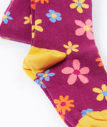 Frugi Norah tights in damson / retro floral available at Babipur. A GOTS organic cotton dark purple tights with a pastel coloured retro flower design and yellow contrasting panels