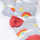 A close up of the red colour block heels on the Frugi Norah tights in grey marl / rainbow available at Babipur. A GOTS organic cotton grey tights with a playful rainbow design and red contrasting heel and toe panels