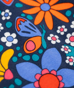 A close up of the details on the print of the Frugi sofia skater dress in navy / retro flowers available at Babipur. A GOTS organic cotton skater dress in navy with a bright retro floral design.