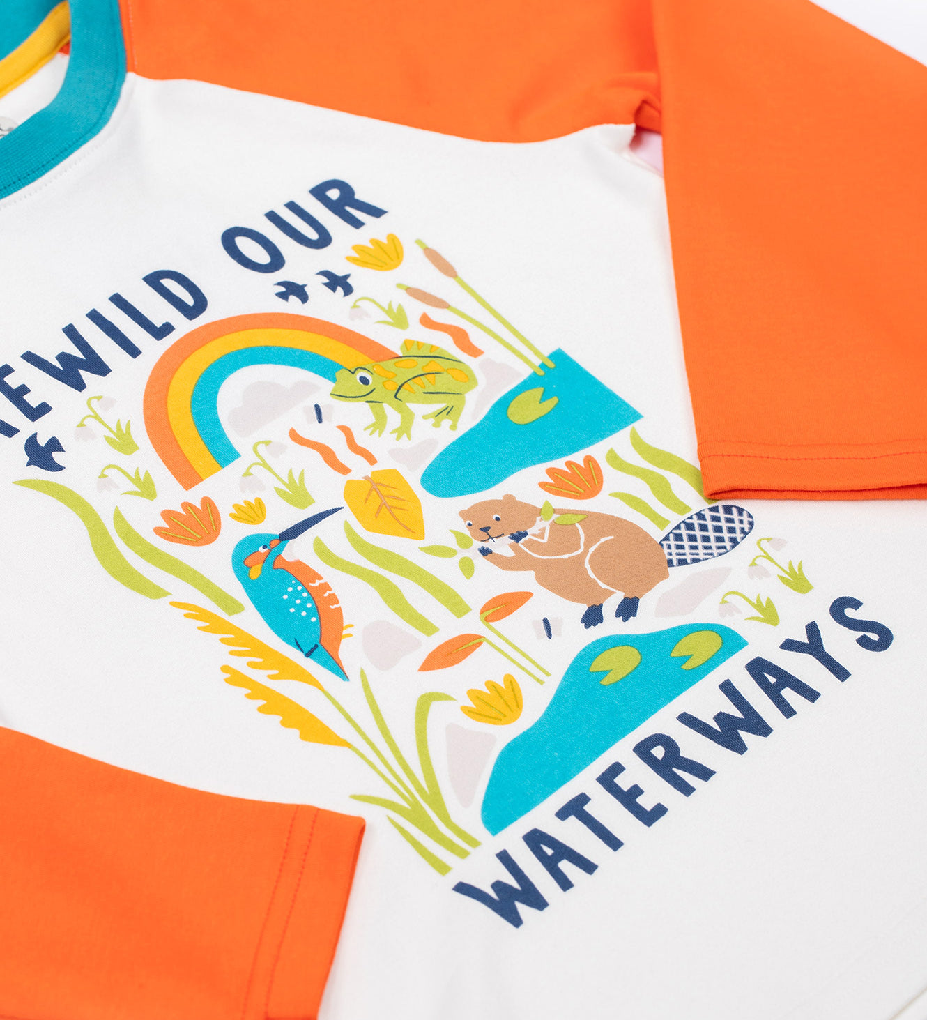 A close up of the graphic on the front of the Frugi tamar raglan top in soft white/waterways available at Babipur. A orange and white GOTS organic cotton long sleeve top with a playful waterways print on the front.