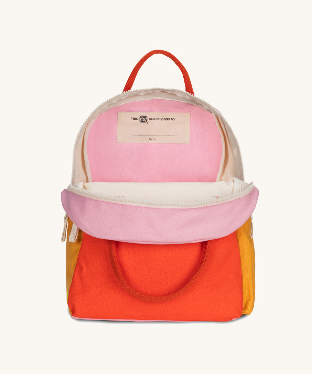 The organic cotton Fluf B-Pack Jr, a kids school backpack, unzipped to show the inside.