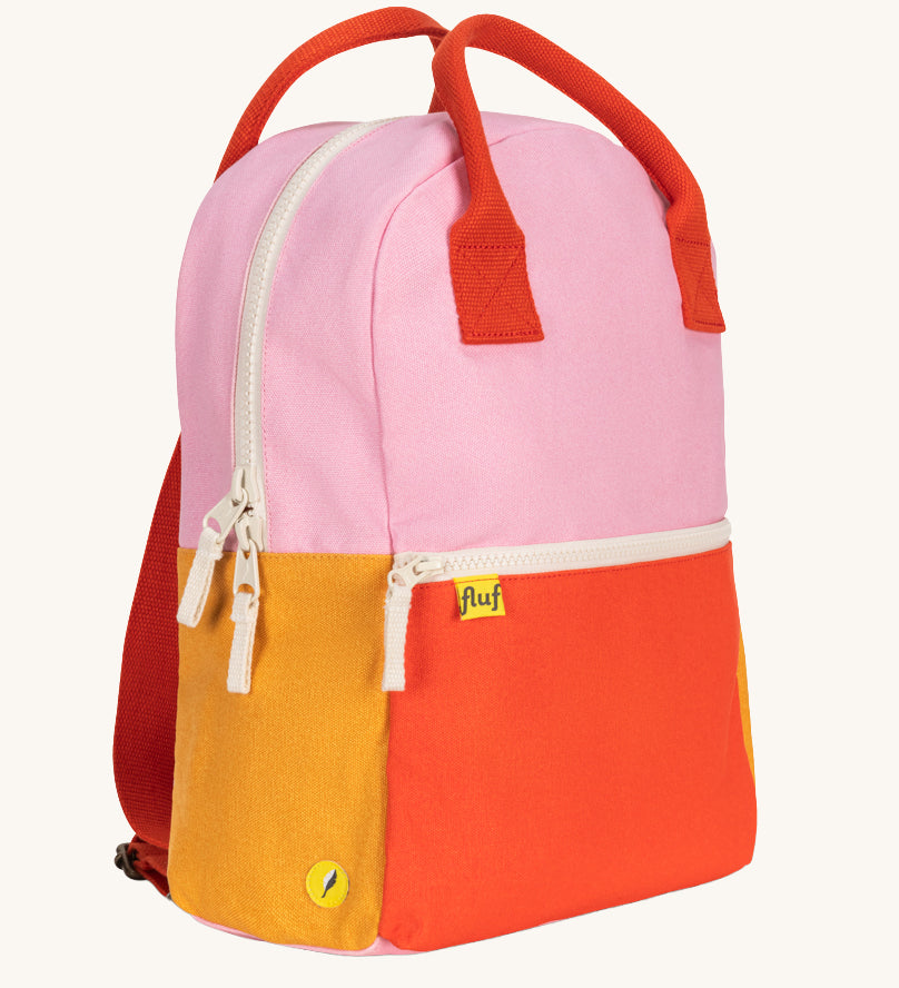 A side view of The organic cotton Fluf B-Pack Jr, a kids school backpack in a bright colour block design