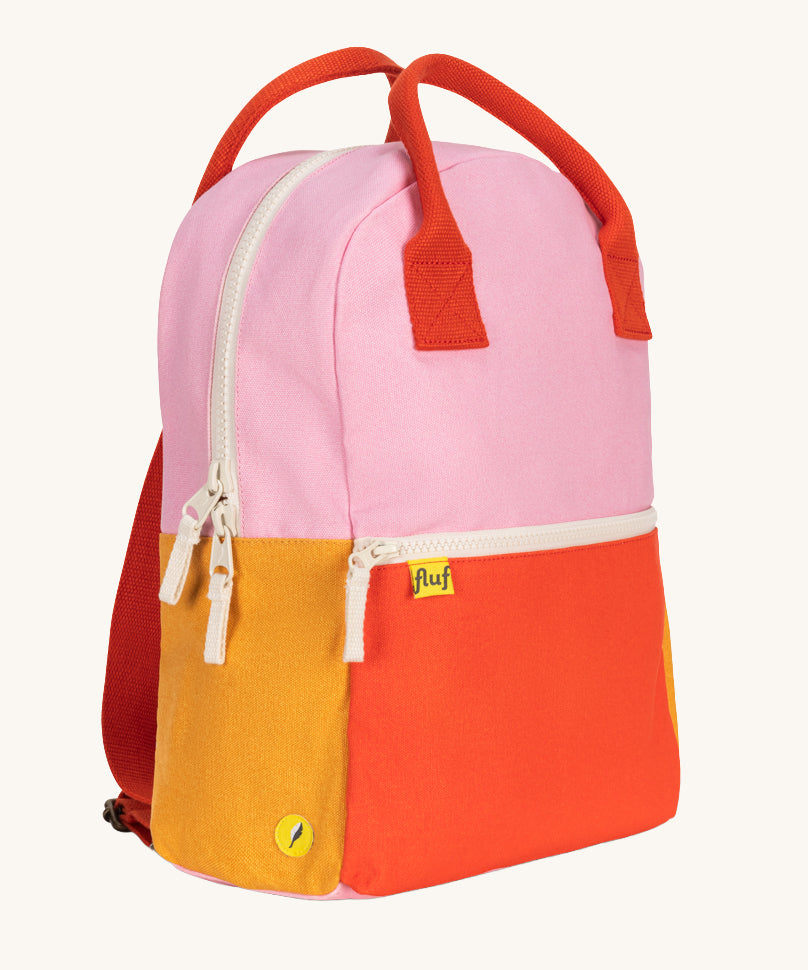 A side view of The organic cotton Fluf B-Pack Jr, a kids school backpack in a bright colour block design