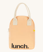 Fluf zip lunch bag in a peach colour with lunch printed on the front in black with a white handle and zip detail on a cream background.