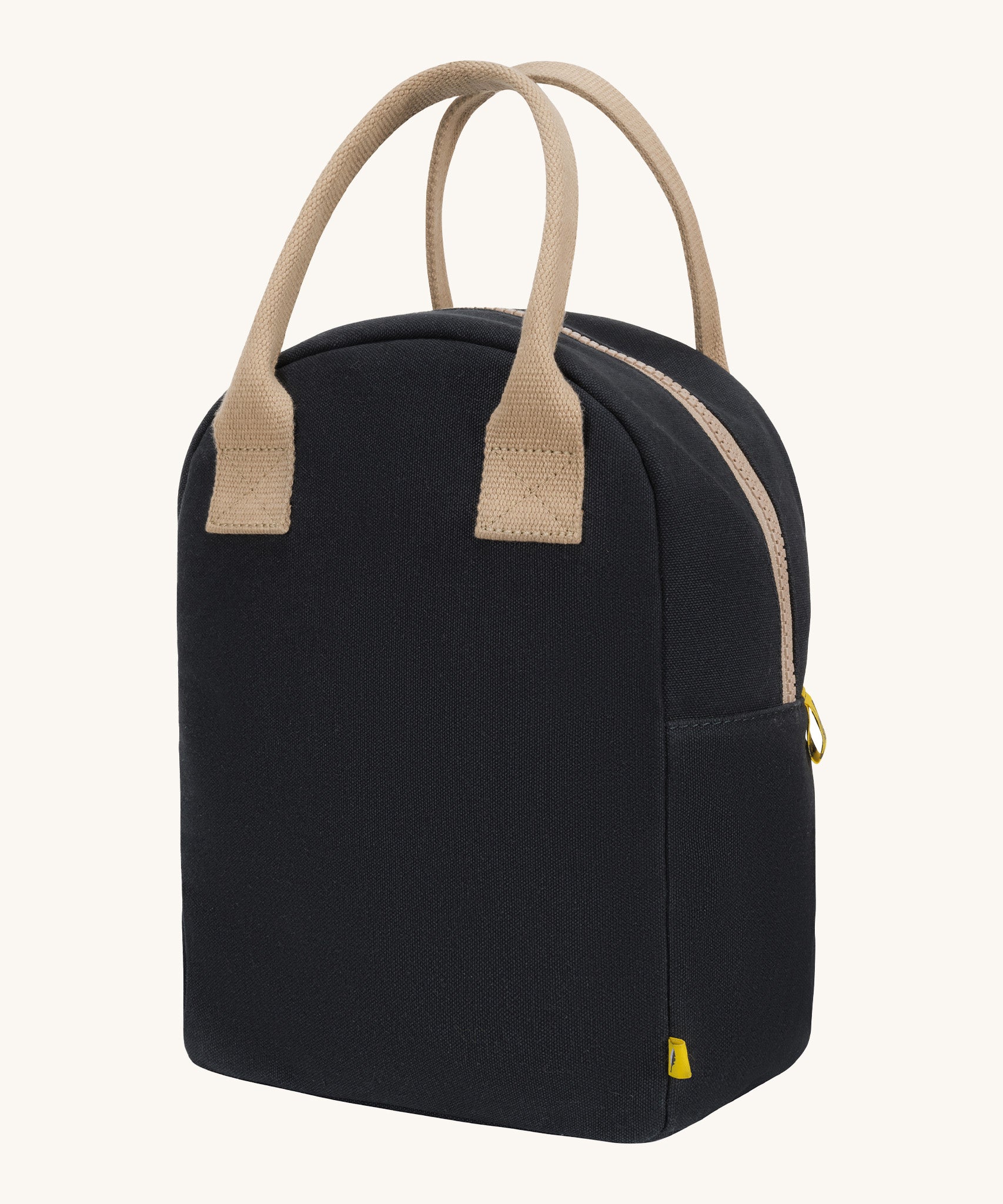 Fluf zip lunch bag in a solid black colour with a light brown handle and light brown zip detail on a cream background.