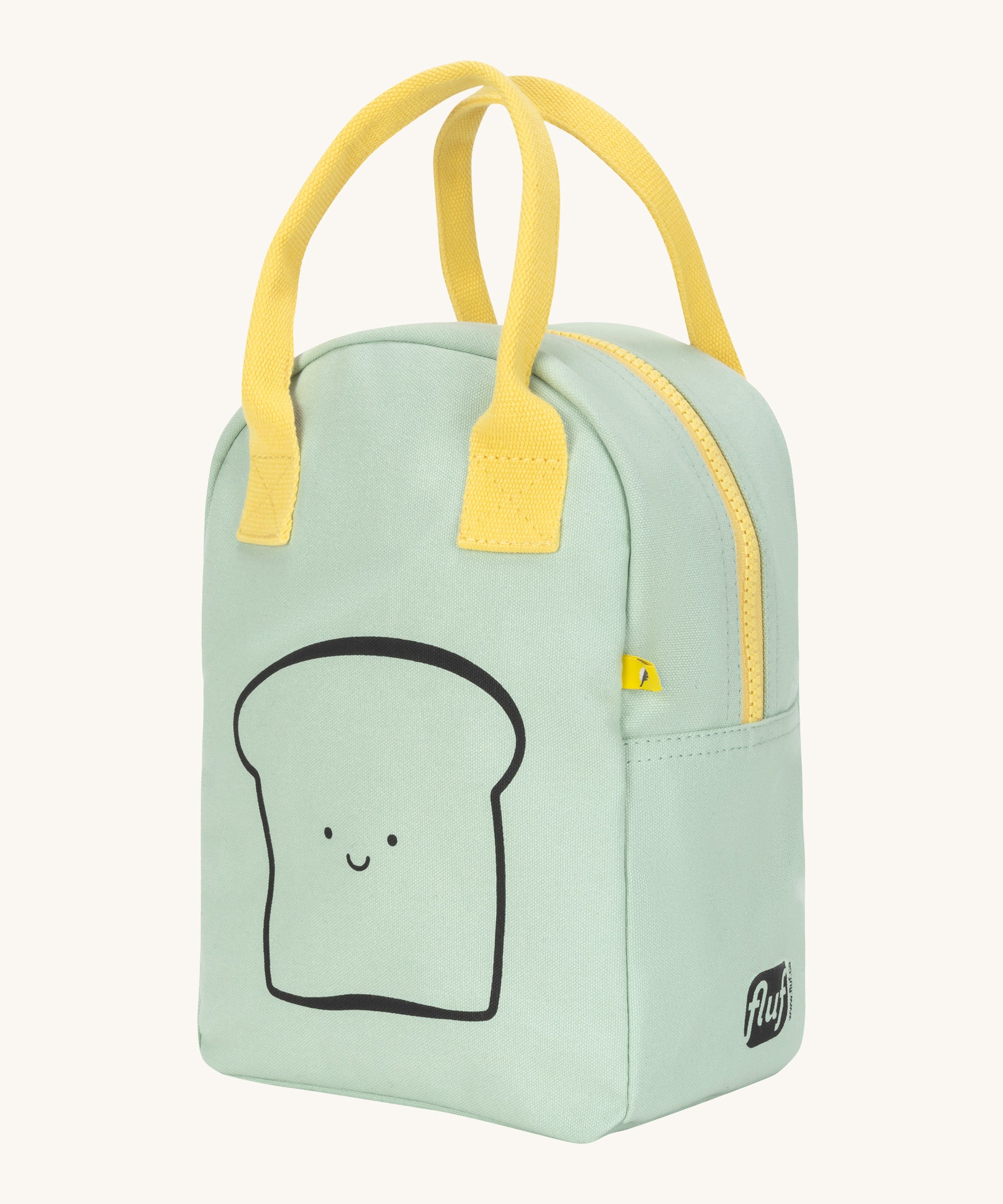 Side view of the Fluf zip lunch bag in light green with a light yellow handle and zip detail. Lunch bag has a playful black outline design of a slice of bread with a smiling face and brand logo in black on the side panel